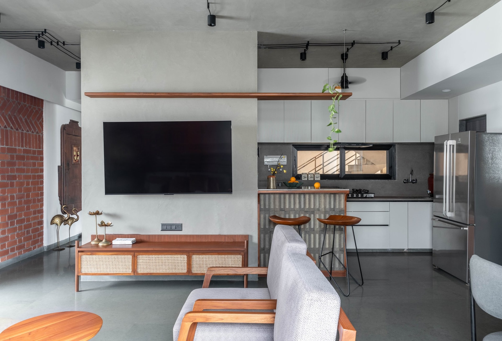 The open kitchen's concrete-block breakfast counter, holding its own against white cabinetry beyond