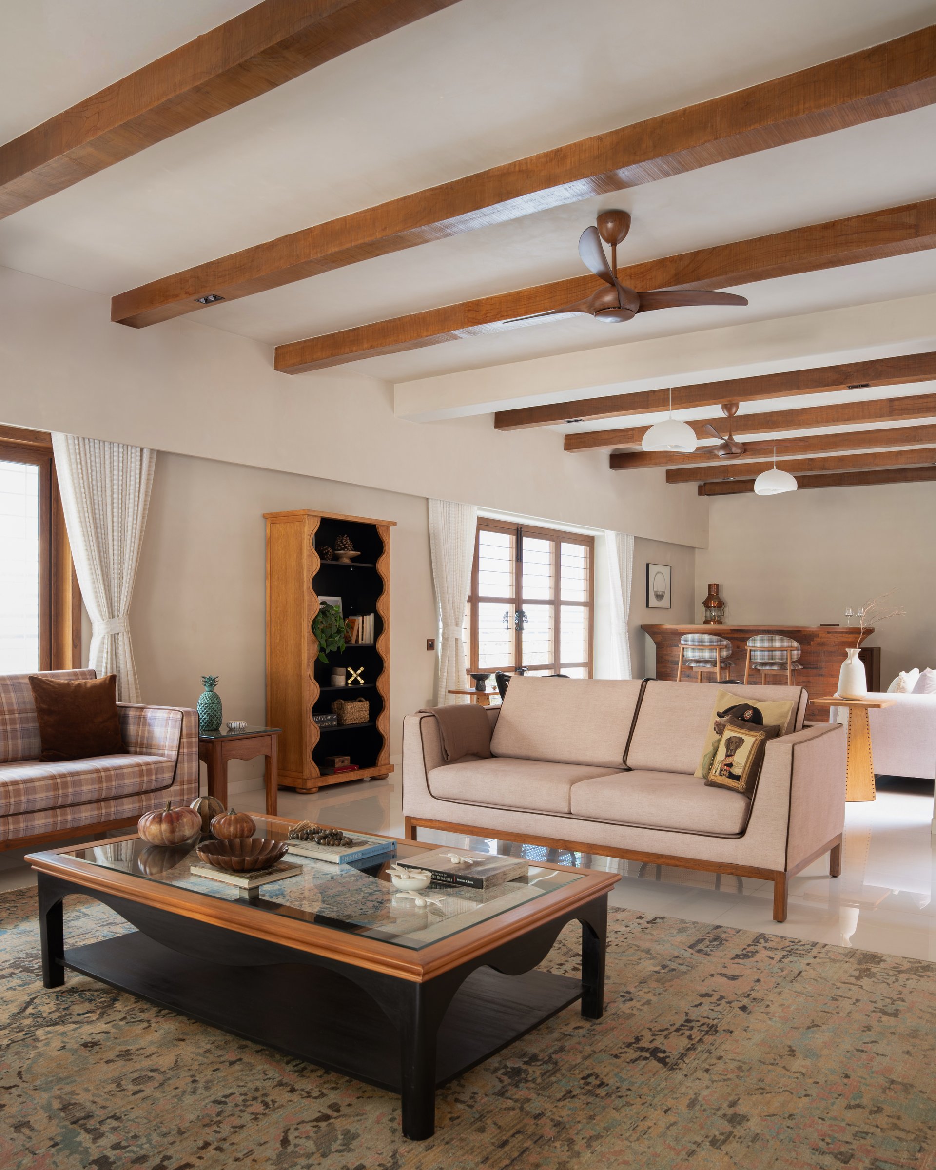 Timber ceiling beams lend a vernacular register to the formal living room